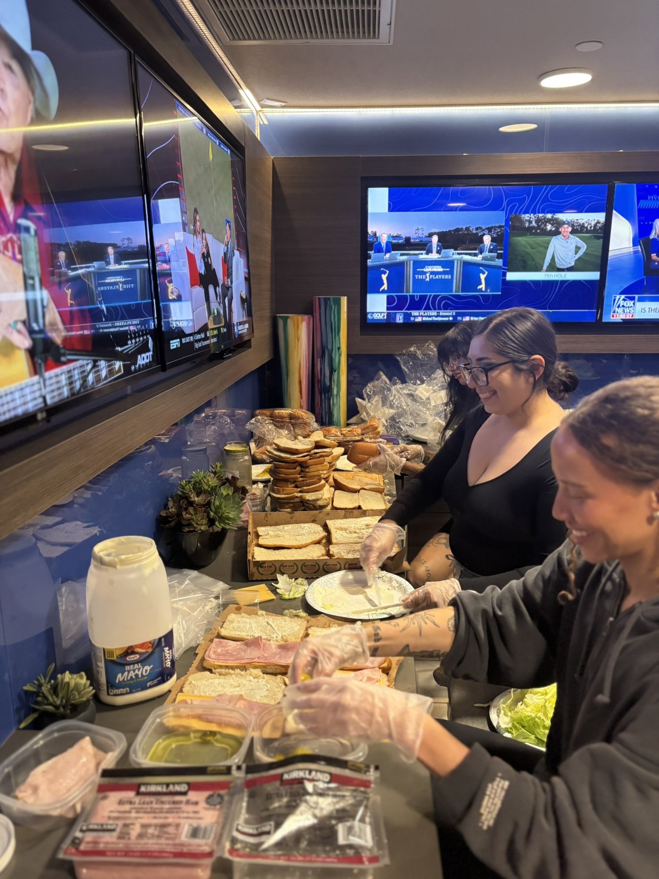 Volunteers making sandwiches together to hand out during outreach