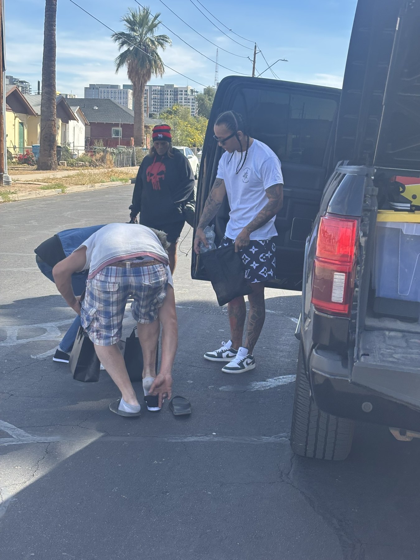 4TK volunteers giving out clothing and water from the back of a truck